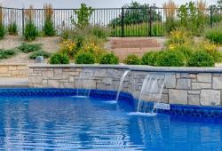 Sheer descent water features built  into the decorative retaining wall  
